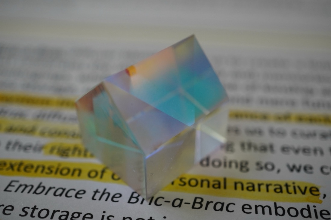A glass house resting on a printed page, with a line of highlighted text beneath it.